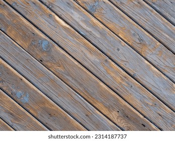 Wood texture background. An old wooden wall with worn diagonal boards with natural patterns. Texture of old wood for design with free space
