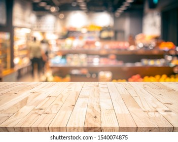 Wood texture table top (counter bar) with blur grocery,market store background.For montage product display or design key visual layout