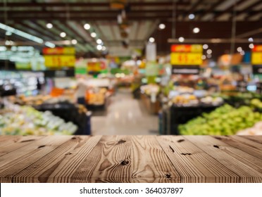 Wood top table on blur supermarket background