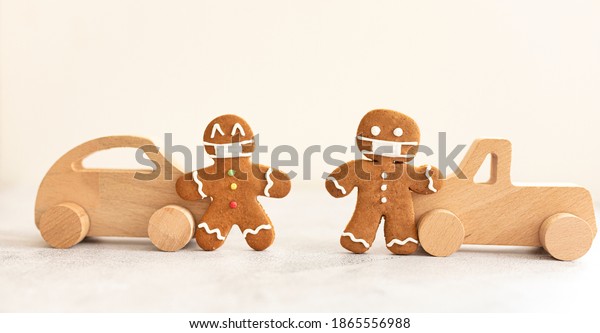 wood toy car gingerbread men with a masks.
Christmas holiday celebration
concept.