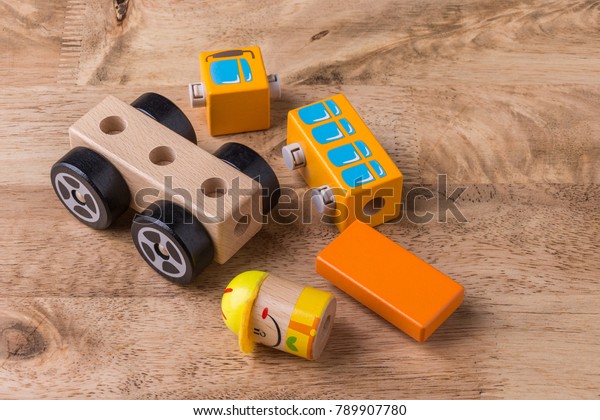 Wood toy puzzle toy\
car on wooden table