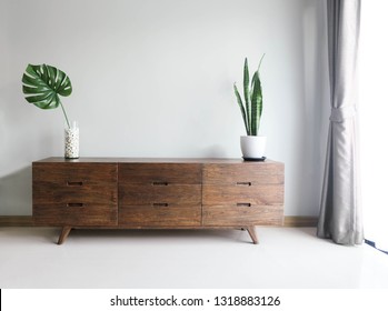 Wood TV cabinet interior wall Mockup with small plant tropical style in living room place with free space in center of picture for present the product. image
