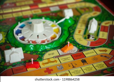 Woodbridge, New Jersey / United States - October 9, 2018: A Circa 1980s Board Game Of Life Is Shown With Colorful Pawns And Background