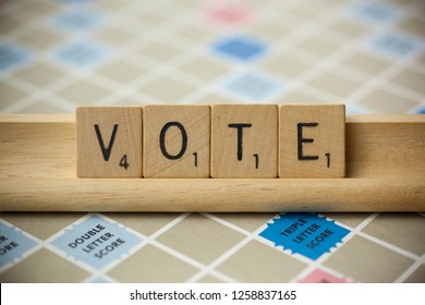 Woodbridge, New Jersey / United States - November 9, 2018: Scrabble Tiles Spell Out The Word Vote On A Vintage Game Board