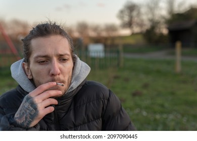 Woodbridge Suffolk UK March 01 2020: A 20 Something Male Smoking A Cannabis Joint To Help With His Health. Alternative Medicine, Medical Marijuana Concept