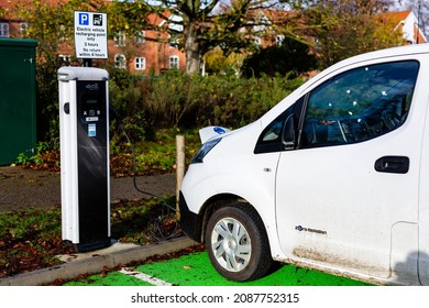 Woodbridge Suffolk UK November 28 2021: Nissan E-NV200 Electric Van Charging At Plug In Charge Station In A Public Car Park In Suffolk, UK