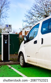 Woodbridge Suffolk UK November 28 2021: Nissan E-NV200 Electric Van Charging At Plug In Charge Station In A Public Car Park In Suffolk, UK