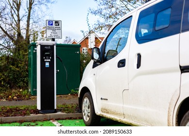 Woodbridge Suffolk UK November 28 2021: Nissan E-NV200 Electric Van Charging At Plug In Charge Station In A Public Car Park In Suffolk, UK