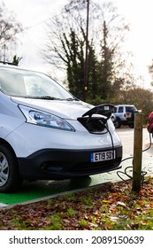 Woodbridge Suffolk UK November 28 2021: Nissan E-NV200 Electric Van Charging At Plug In Charge Station In A Public Car Park In Suffolk, UK