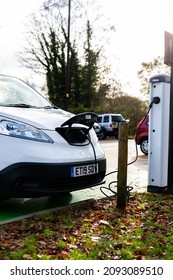 Woodbridge Suffolk UK November 28 2021: Nissan E-NV200 Electric Van Charging At Plug In Charge Station In A Public Car Park In Suffolk, UK