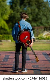 Woodbridge, Suffolk, UK September 13 2020: A 20 Something Female Relaxing And Posing With Her Acoustic Guitar