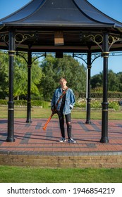 Woodbridge, Suffolk, UK September 13 2020: A 20 Something Female Relaxing And Posing With Her Acoustic Guitar