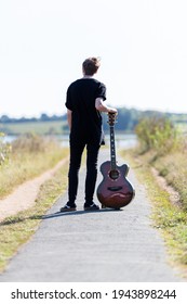 Woodbridge, Suffolk, UK September 20 2020: A 20 Something Female Relaxing And Posing With Her Acoustic Guitar