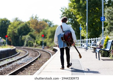 Woodbridge, Suffolk, UK September 20 2020: A 20 Something Female Relaxing And Posing With Her Acoustic Guitar