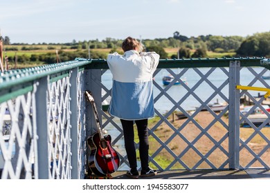 Woodbridge, Suffolk, UK September 20 2020: A 20 Something Female Relaxing And Posing With Her Acoustic Guitar