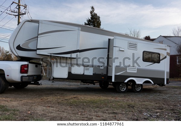 Woodbridge, Virginia, USA - March 15, 2018 -\
Fifth Wheel RV Recreation Vehicle 5th Slides Out Pulled By Diesel\
Truck Towing Camper\
Trailer