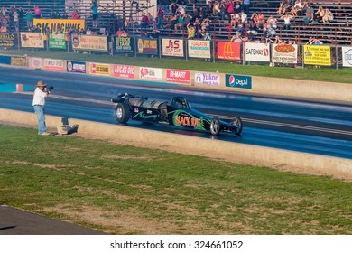 WOODBURN, OR - SEPTEMBER 27, 2015: Darin Bay's Warped Speed Black Rat Jet Dragster Eclipses 250mph During The NHRA 30th Annual Fall Classic At The Woodburn Dragstrip.