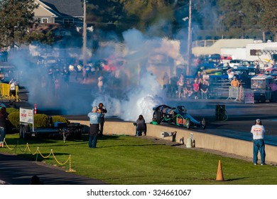 WOODBURN, OR - SEPTEMBER 27, 2015: Darin Bay's Warped Speed Black Rat Jet Dragster Blows Fire And Smoke Towards Spectators During The NHRA 30th Annual Fall Classic At The Woodburn Dragstrip.