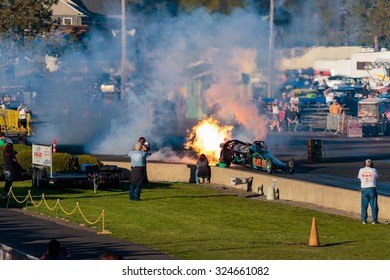 WOODBURN, OR - SEPTEMBER 27, 2015: Darin Bay's Warped Speed Black Rat Jet Dragster Blows Fire And Smoke Towards Spectators During The NHRA 30th Annual Fall Classic At The Woodburn Dragstrip.