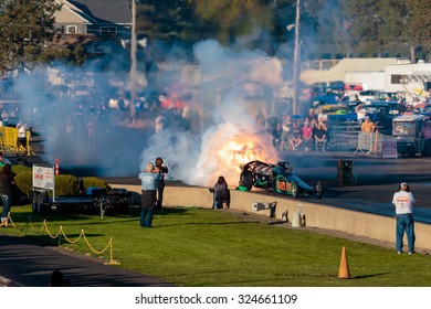 WOODBURN, OR - SEPTEMBER 27, 2015: Darin Bay's Warped Speed Black Rat Jet Dragster Blows Fire And Smoke Towards Spectators During The NHRA 30th Annual Fall Classic At The Woodburn Dragstrip.