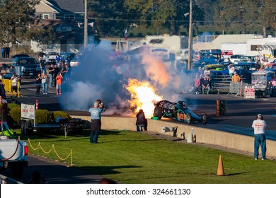 WOODBURN, OR - SEPTEMBER 27, 2015: Darin Bay's Warped Speed Black Rat Jet Dragster Blows Fire And Smoke Towards Spectators During The NHRA 30th Annual Fall Classic At The Woodburn Dragstrip.