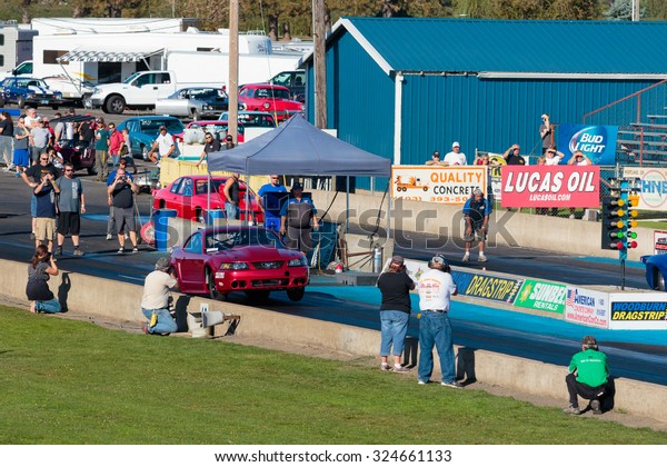 WOODBURN, OR - SEPTEMBER 27, 2015:\
Turbo boosted Ford Mustang with front wheels off the track at the\
NHRA 30th Annual Fall Classic at the Woodburn\
Dragstrip.
