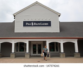 WOODBURY COMMON - JULY 9: Shoppers walk past a Ralph Lauren Polo retail clothing outlet store in Woodbury Common, New York, on Tuesday, July 9, 2013. 
