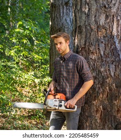 Woodcutter With Chainsaw Lumberjack With Axe. Hipsters Men On Serious Face With Axe. Lumberjack Brutal Holds Axe.