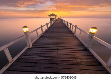 Wooded bridge in the port between sunrise