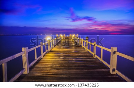 Wooded bridge in the port between sunrise.