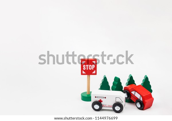 Wooded
toy car are crashed. Accident road traffic with wooden toy cars in
the town on white background, safety and traffic regulations
concept, backgrounds.Transportation system
concept