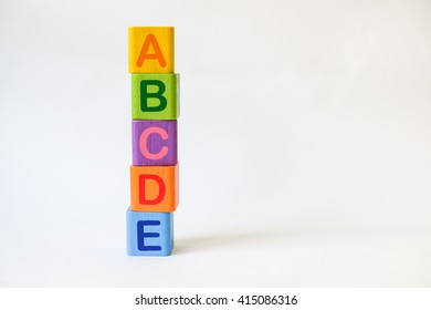Wooden ABC Blocks on white background with copyspace