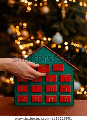 wooden advent calendar in the form of a house under the christmas tree surprise expectation countdown timer new year's eve play with children family evening leisure game creativity 1  month