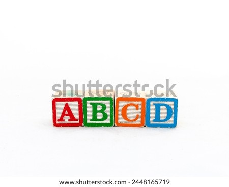 Wooden Alphabet Blocks ABCD isolated on white background with copy space.