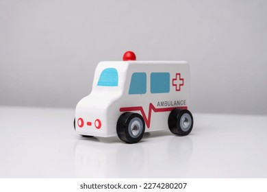 wooden ambulance toy car on white table