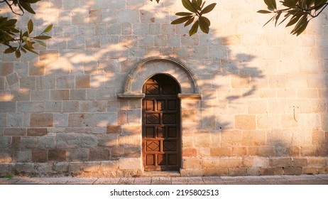 Wooden Arch Door In  Monumental Stone Facade