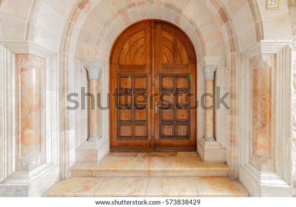 Wooden arched double\
doors