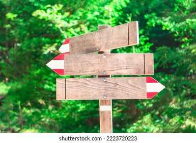 Wooden arrow boards . Wood arrow signs for tourists . Direction indicators for hiking - Powered by Shutterstock