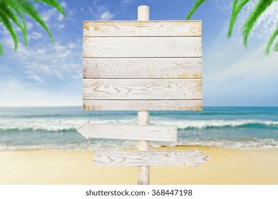 Wooden Arrow Signs On Beach Background