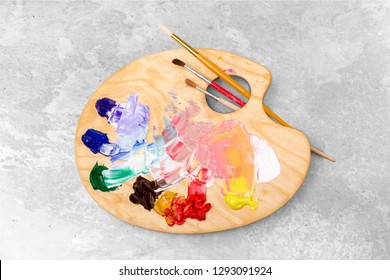 Wooden art palette with blobs of paint