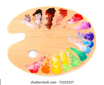 Wooden Art Palette With Blobs Of Paint And A Brush On White Background