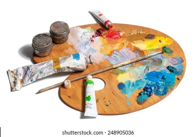 Wooden Art Palette With  Tubes Of Oil Paints And A Brush Isolated On White Background