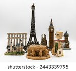 Wooden artisan robot next to several world monuments such as the Eiffel Tower, Patio de los Leones de la Alhambra and Big Ben