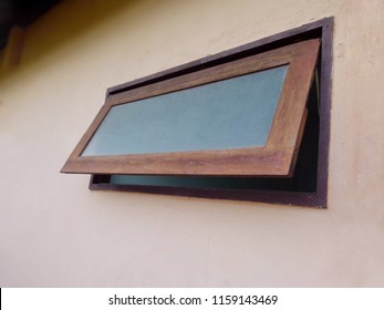 Wooden Awning Window On Cement Wall.