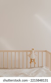 Wooden Baby Room Furniture. Bed Crib, Toy Duck, Muslin Blanket. Baby Bedroom Modern Interior With White Walls