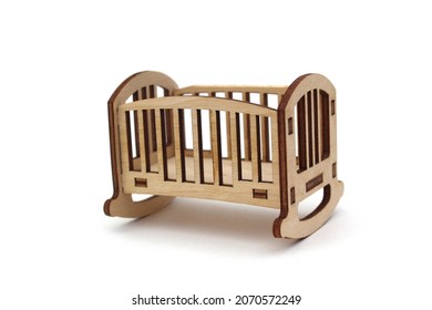 Wooden baby toy bed assembled from plywood on a white isolated background. - Shutterstock ID 2070572249