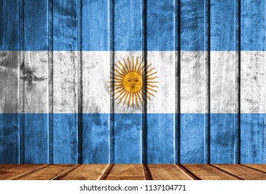 Wooden background with a flag of Argentina.