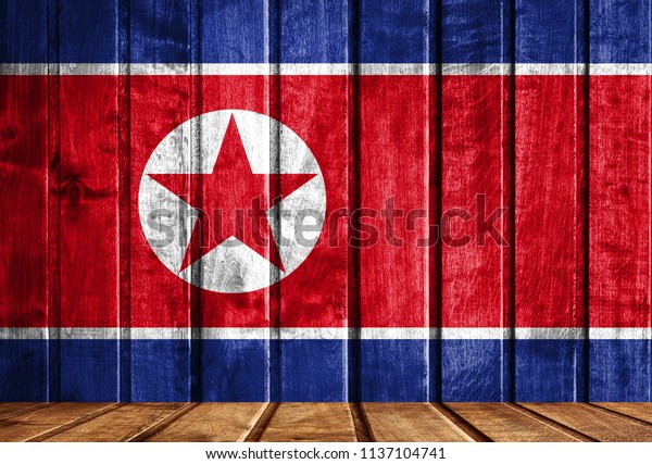 Wooden background\
with a flag of North\
Korea.