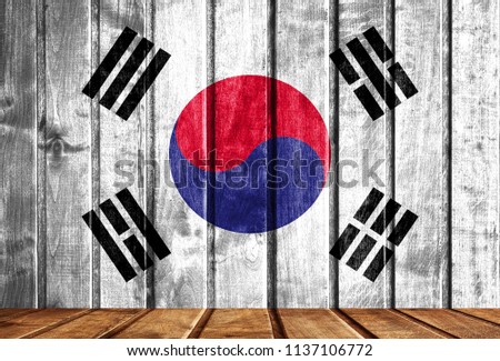 Wooden background with a flag of South Korea.