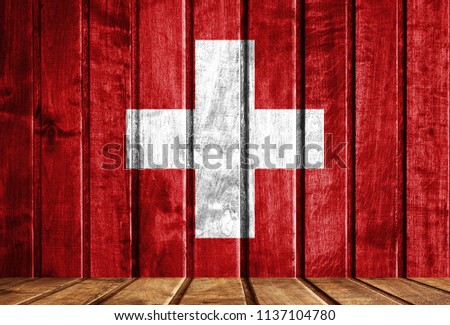 Wooden background with a flag of Switzerland.